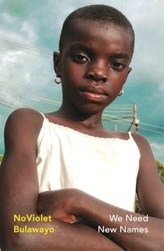 A book cover with a photo of a short-haired African girl, arms crossed, looking defiant.